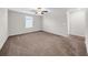 Neutral bedroom boasts soft carpet, a ceiling fan, a window with blinds, and ample natural light at 9505 Lemon Drop Loop, Ruskin, FL 33573