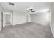 Expansive bedroom with soft carpet, ceiling fan, and multiple doors leading to other areas at 9505 Lemon Drop Loop, Ruskin, FL 33573