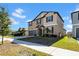 Well-maintained two-story home with a two-car garage, showcasing a tidy lawn and classic design elements at 9505 Lemon Drop Loop, Ruskin, FL 33573