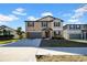 Charming two-story home with a neatly kept lawn, featuring a two-car garage and inviting curb appeal at 9505 Lemon Drop Loop, Ruskin, FL 33573