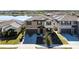 Two-story home featuring a well-manicured lawn, two-car garage, and a serene lake view at 9505 Lemon Drop Loop, Ruskin, FL 33573