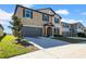 Attractive two-story home with a spacious two-car garage, highlighted by its clean landscaping and pleasant facade at 9505 Lemon Drop Loop, Ruskin, FL 33573