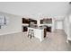 Spacious kitchen boasts dark wood cabinets, stainless steel appliances and a large island with a breakfast bar at 9505 Lemon Drop Loop, Ruskin, FL 33573