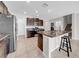 Well-equipped kitchen featuring dark cabinetry, granite countertops, and modern stainless steel appliances at 9505 Lemon Drop Loop, Ruskin, FL 33573
