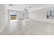 Bright living room features tile floors, a ceiling fan, and sliding glass doors to the backyard at 9505 Lemon Drop Loop, Ruskin, FL 33573
