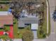 Birds eye view of the home with a well-kept yard, lush greenery, and a convenient carport at 9862 48Th N Ave, St Petersburg, FL 33708