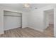 Bright bedroom features wood-look flooring, closet, and an open door at 9862 48Th N Ave, St Petersburg, FL 33708