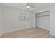 Bright bedroom features wood-look flooring, closet, and a ceiling fan at 9862 48Th N Ave, St Petersburg, FL 33708