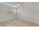 Bright bedroom featuring neutral paint, wood-look floors, and a ceiling fan at 9862 48Th N Ave, St Petersburg, FL 33708