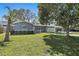 Charming single-story home featuring a manicured lawn, lush landscaping, and a carport for convenient parking at 9862 48Th N Ave, St Petersburg, FL 33708