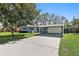Inviting single-story home with a spacious driveway, attached carport, and well-maintained front yard at 9862 48Th N Ave, St Petersburg, FL 33708