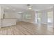Bright and airy living room with new floors, a ceiling fan, and abundant natural light at 9862 48Th N Ave, St Petersburg, FL 33708