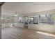 Light-filled sunroom with wood-look floors, lots of windows and a ceiling fan at 9862 48Th N Ave, St Petersburg, FL 33708