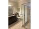 Bathroom featuring granite countertops, dark brown cabinets and glass walk-in shower at 11648 Palmetto Pine St, Riverview, FL 33569