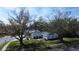 Charming single-story home with a well-manicured lawn and mature trees, seen from a serene aerial perspective at 1022 Mctavish Way, Palm Harbor, FL 34684