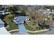 Breathtaking aerial view of a charming home showcasing its well-maintained landscaping, driveway, and surrounding neighborhood at 1022 Mctavish Way, Palm Harbor, FL 34684