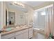 Neutral bathroom featuring an extended countertop, full mirror, and a shower/tub combo at 1022 Mctavish Way, Palm Harbor, FL 34684