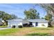 Inviting single-story home with a fresh exterior, attached garage, and a well-maintained front lawn at 1022 Mctavish Way, Palm Harbor, FL 34684