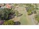 Scenic aerial view of the golf course with lush green fairways surrounded by mature trees and community homes at 1022 Mctavish Way, Palm Harbor, FL 34684