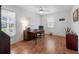 Well-lit home office with wood flooring, a ceiling fan, and a view of the outdoors at 1022 Mctavish Way, Palm Harbor, FL 34684