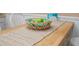 Close-up of kitchen island decor, including a basket filled with decorative fruit and a runner at 1022 Mctavish Way, Palm Harbor, FL 34684