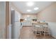 Bright kitchen with white appliances, lots of cabinets, and a tile floor at 1022 Mctavish Way, Palm Harbor, FL 34684