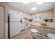 Bright kitchen featuring white appliances, lots of cabinets, and an island with seating at 1022 Mctavish Way, Palm Harbor, FL 34684