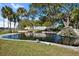 Scenic pond with a small waterfall feature and lush greenery, part of the Highland Lakes community at 1022 Mctavish Way, Palm Harbor, FL 34684