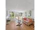 Inviting sun room with tropical decor, natural light, and views of the landscaped backyard at 1022 Mctavish Way, Palm Harbor, FL 34684