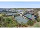Aerial view of multiple tennis courts and pickleball courts at a Primary planned community at 14191 Heritage Landing Boulevard # 1234, Punta Gorda, FL 33955