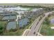 Aerial view of tennis and pickleball courts, clubhouse, and surrounding community at 14191 Heritage Landing Boulevard # 1234, Punta Gorda, FL 33955