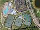 Overhead aerial shot displaying community amenities: a pool, tennis courts, and ample parking at 14191 Heritage Landing Boulevard # 1234, Punta Gorda, FL 33955