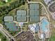 Bird's eye view of community amenities including tennis courts, a pool, and clubhouse, for active living at 14191 Heritage Landing Boulevard # 1234, Punta Gorda, FL 33955
