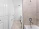 Modern bathroom features tiled shower, neutral tile floor, and white vanity at 14191 Heritage Landing Boulevard # 1234, Punta Gorda, FL 33955
