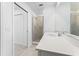 Bright bathroom with a glass shower, white vanity, and tile floors at 14191 Heritage Landing Boulevard # 1234, Punta Gorda, FL 33955