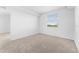 Bright bedroom features plush carpeting, natural light, and neutral walls at 14191 Heritage Landing Boulevard # 1234, Punta Gorda, FL 33955