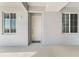 Bright condo entryway featuring a white door, welcome mat, and natural light from adjacent windows at 14191 Heritage Landing Boulevard # 1234, Punta Gorda, FL 33955