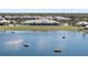 Scenic golf course view with a large lake, lush green fairways, and a clubhouse in a beautiful community at 14191 Heritage Landing Boulevard # 1234, Punta Gorda, FL 33955