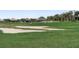 Beautiful golf course with players, sand traps, and lush green grass, surrounded by community homes at 14191 Heritage Landing Boulevard # 1234, Punta Gorda, FL 33955