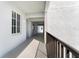 View of the hallway with black railings and stucco columns at 14191 Heritage Landing Boulevard # 1234, Punta Gorda, FL 33955