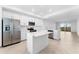 Bright kitchen with stainless steel appliances, white cabinets, central island, and an open layout at 14191 Heritage Landing Boulevard # 1234, Punta Gorda, FL 33955
