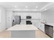 Elegant kitchen featuring white cabinets, stainless steel appliances, an island, and plenty of counter space at 14191 Heritage Landing Boulevard # 1234, Punta Gorda, FL 33955