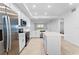 Modern kitchen features stainless appliances, white cabinetry, quartz countertops, and an open layout at 14191 Heritage Landing Boulevard # 1234, Punta Gorda, FL 33955