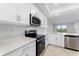 Modern kitchen features stainless appliances, white cabinetry, quartz countertops, and an open layout at 14191 Heritage Landing Boulevard # 1234, Punta Gorda, FL 33955