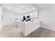 Modern kitchen with white cabinetry, quartz countertops, stainless steel appliances, and an island at 14191 Heritage Landing Boulevard # 1234, Punta Gorda, FL 33955