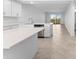 Open concept kitchen features stainless steel appliances, white cabinets, an island, and a breakfast bar at 14191 Heritage Landing Boulevard # 1234, Punta Gorda, FL 33955