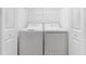 An alcove with a full size washer and dryer with shelf above at 14191 Heritage Landing Boulevard # 1234, Punta Gorda, FL 33955