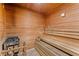 Inviting sauna featuring wooden benches, a heater, and a traditional wooden bucket and ladle at 14191 Heritage Landing Boulevard # 1234, Punta Gorda, FL 33955