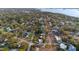 Expansive aerial view of the neighborhood with mature trees and charming homes near the water at 1787 Pasadena Dr, Dunedin, FL 34698