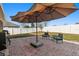 An outdoor patio area is furnished with comfortable seating and a large umbrella at 18130 Arbor Crest Dr, Hudson, FL 34667